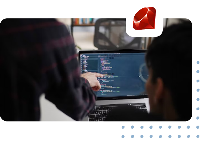 coding bootcamp teacher pointing to students laptop