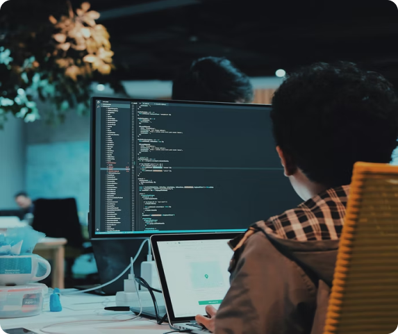 man on computer working on javascript coding	