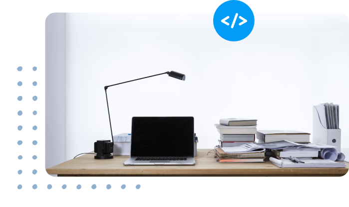 Office desk with laptop and books on top