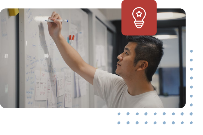Coding student writing on a whiteboard