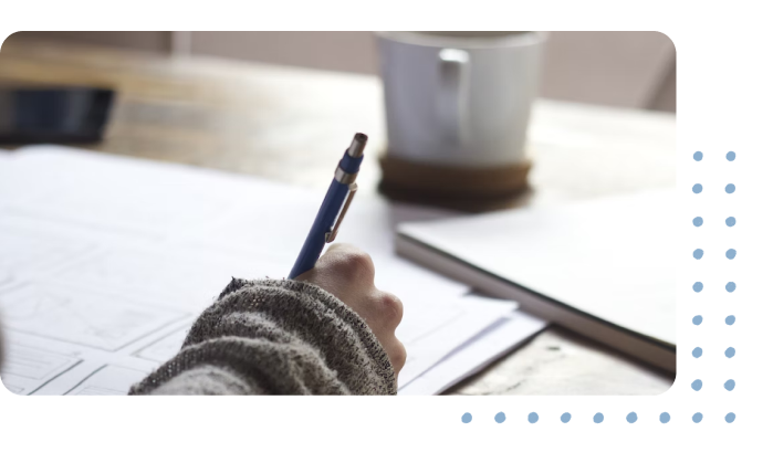 Woman writing on a piece of paper with a pen