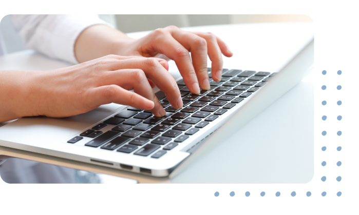  A person’s hands typing on a laptop